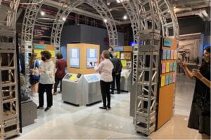 Making History Accessible Exhibit in the Intrepid Museum with Visitors interacting with exhibits while wearing masks.