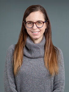 Headshot of Holly Cohen against a gray background