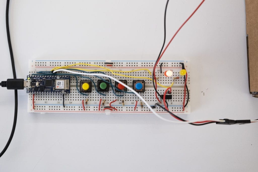 Breadboard with four buttons and one LED lit