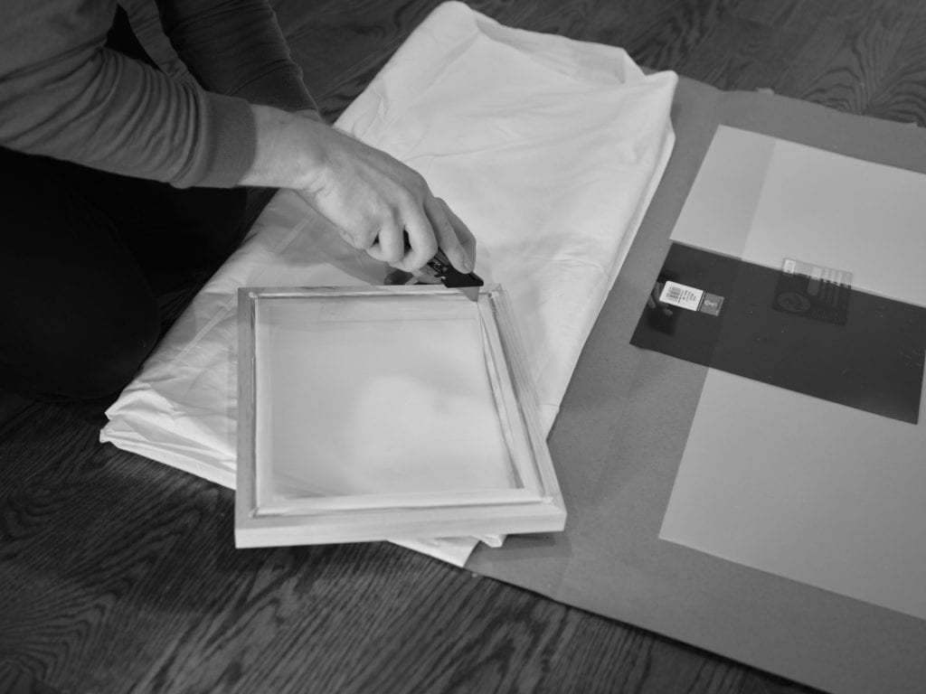 Noah removing a screen printing screen/