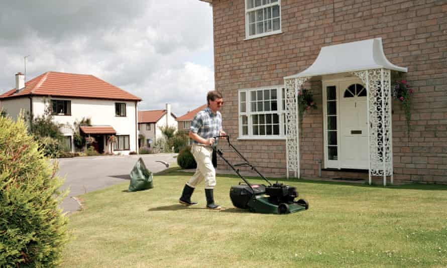 man mowing a backyard