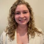 Headshot of Alyssa Moore smiling at camera.