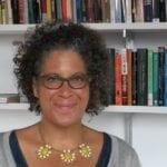 Headshot of Jennifer L. Morgan smiling at camera with bookcases in the background.