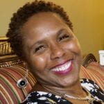 Headshot of Karin Burrell smiling at camera.