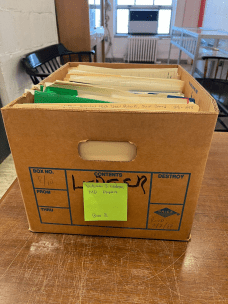 A box of documents labeled "William J. Ledger, MD Papers, Box 8," on a table in the archive.