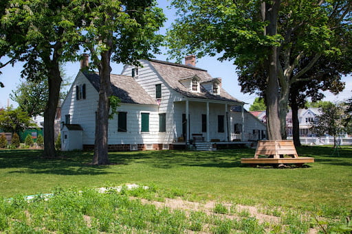 The Hendrick I. Lott House, with trees in the foreground.