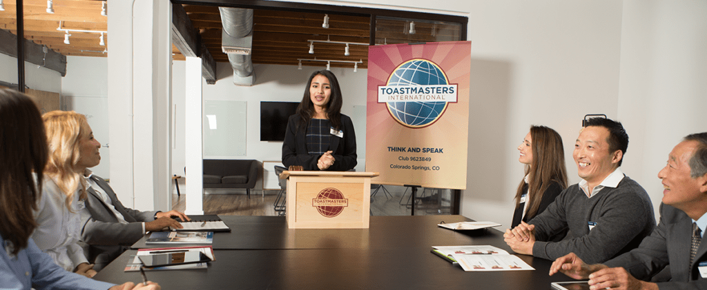 Toastmasters members talk at table