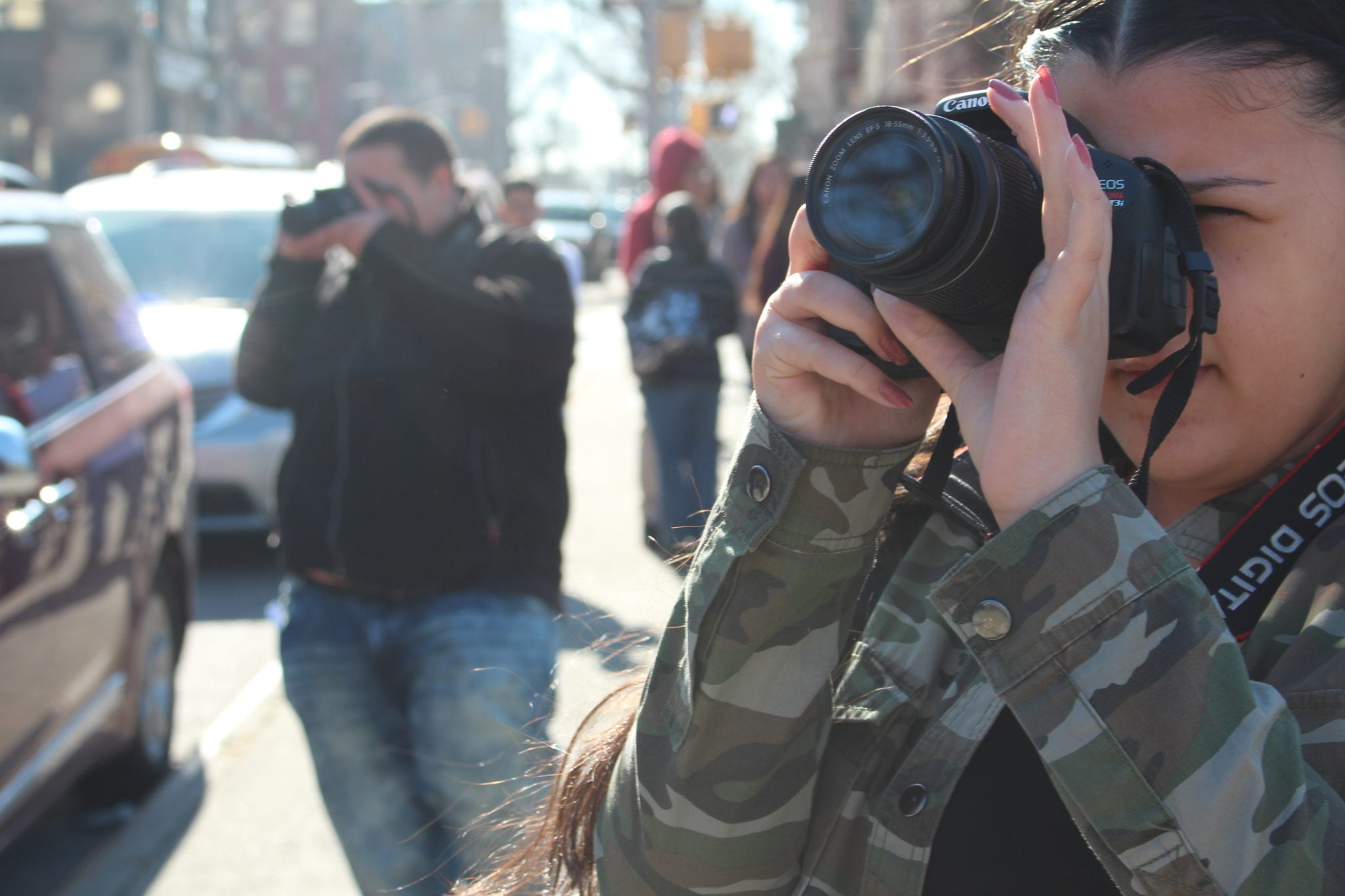 Student taking a photo with a camera. 