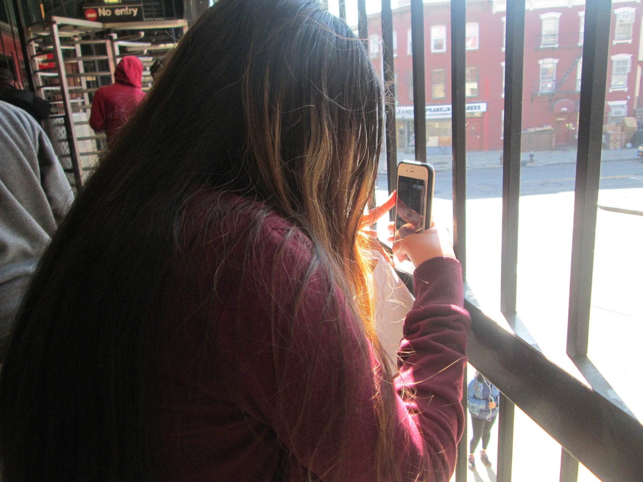 Student taking a photo with an iPhone. 