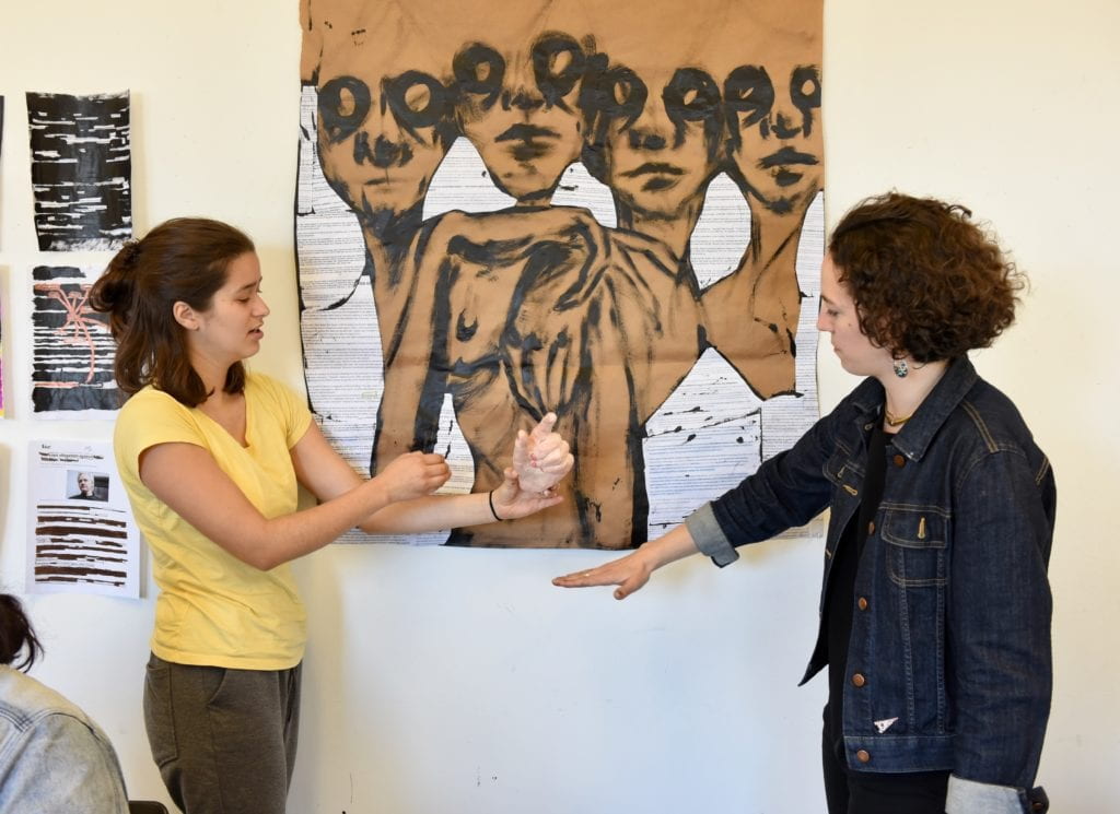 Students in front of artwork. 