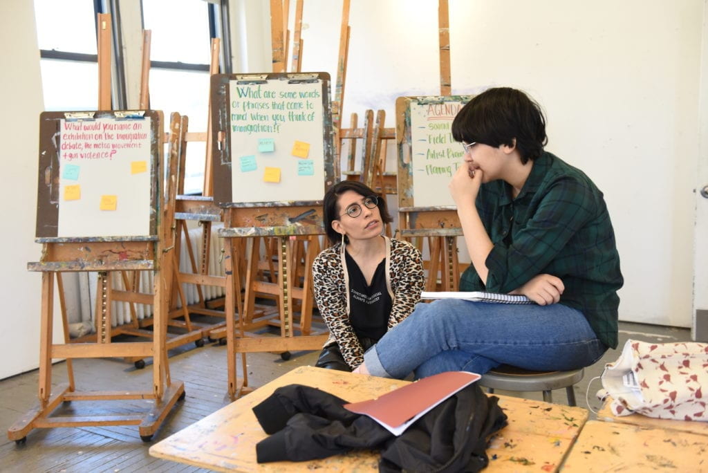 Two people talking in the studio