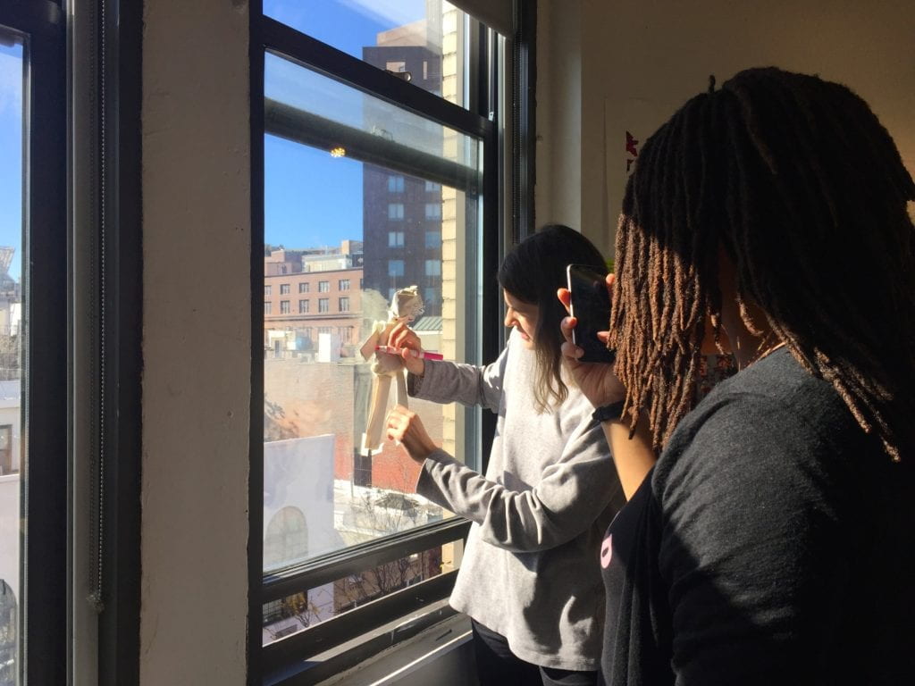 Students tracing at a window