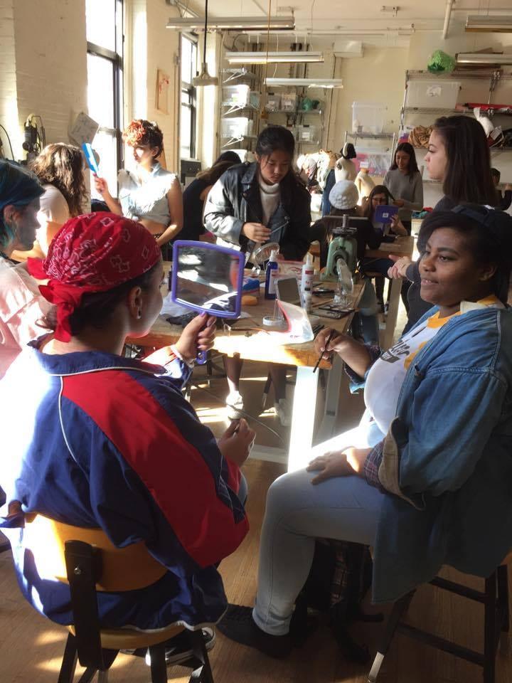 Students using face paint during Gender Lines class. 