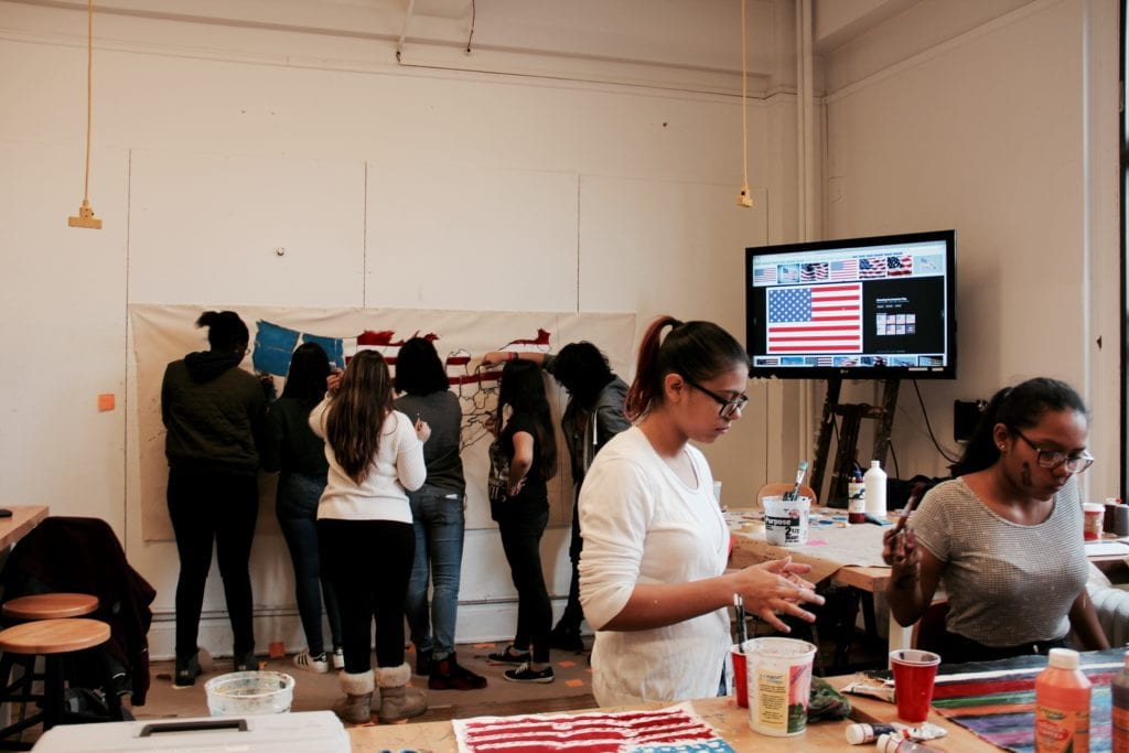 Students painting the United States on a large canvas