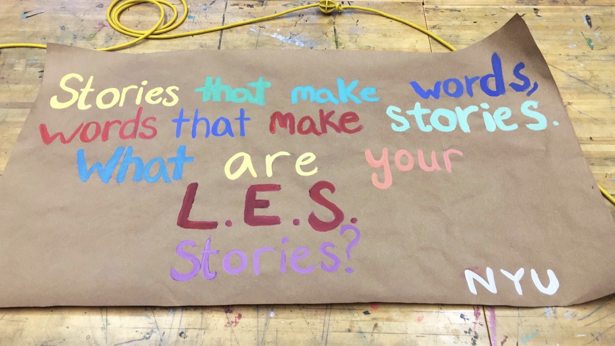 Workshop sign that reads: "Stories that make words, words that make stories. What are your L.E.S. stories?