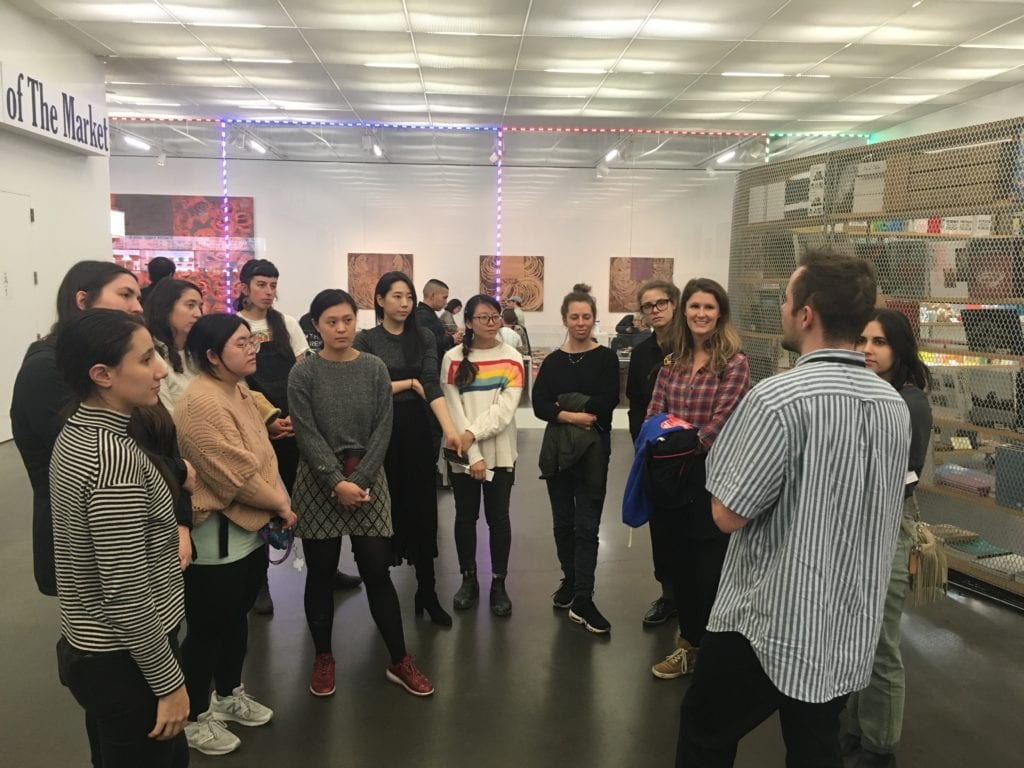 A tour group gathers in the lobby of the New Museum.