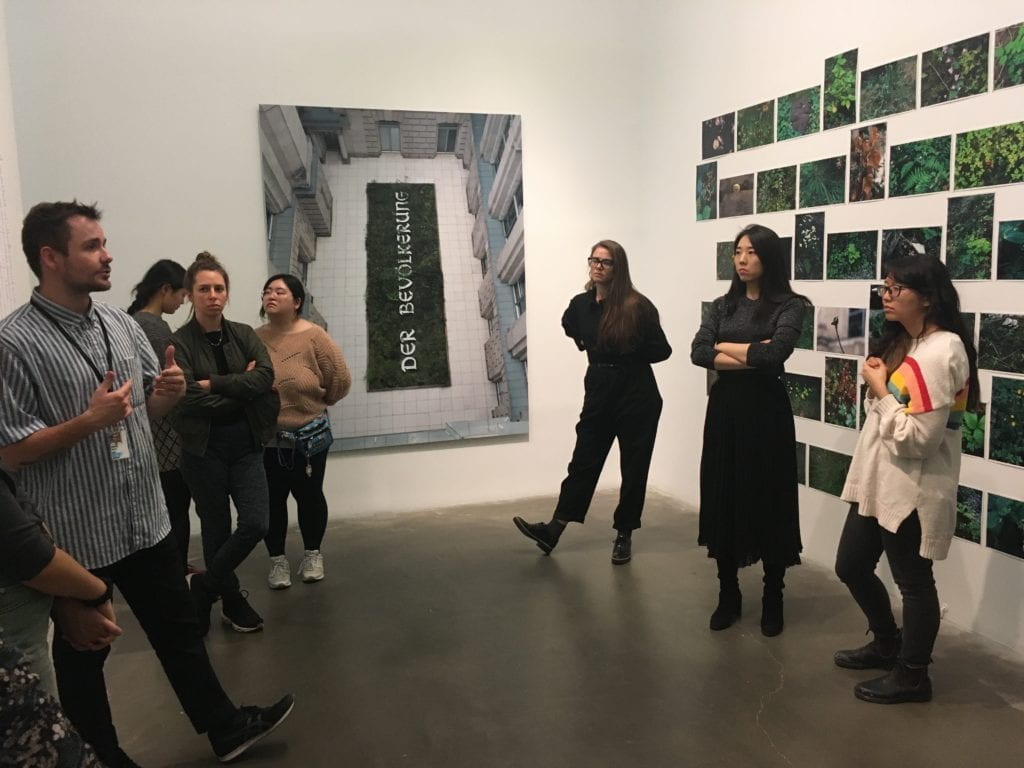 Alumni Peter Tresnan leading a tour group at the New Museum.