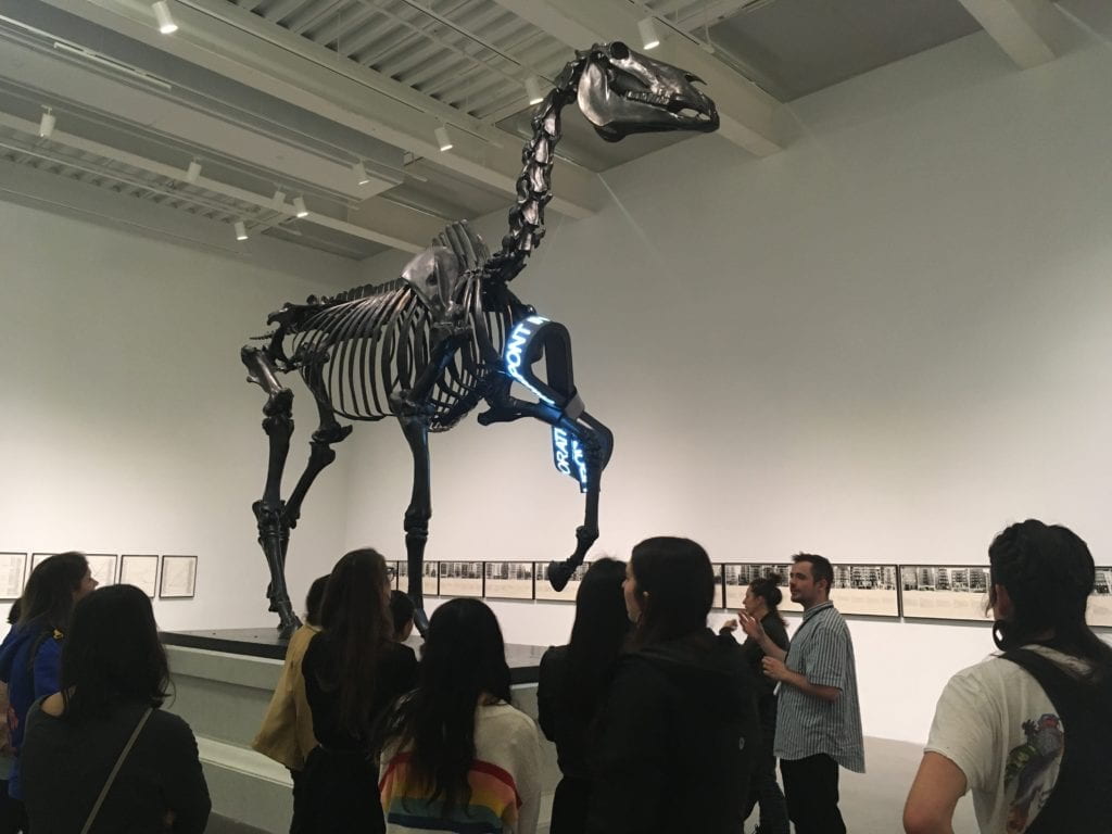 Alumni Peter Tresnan leading a tour group at the New Museum.