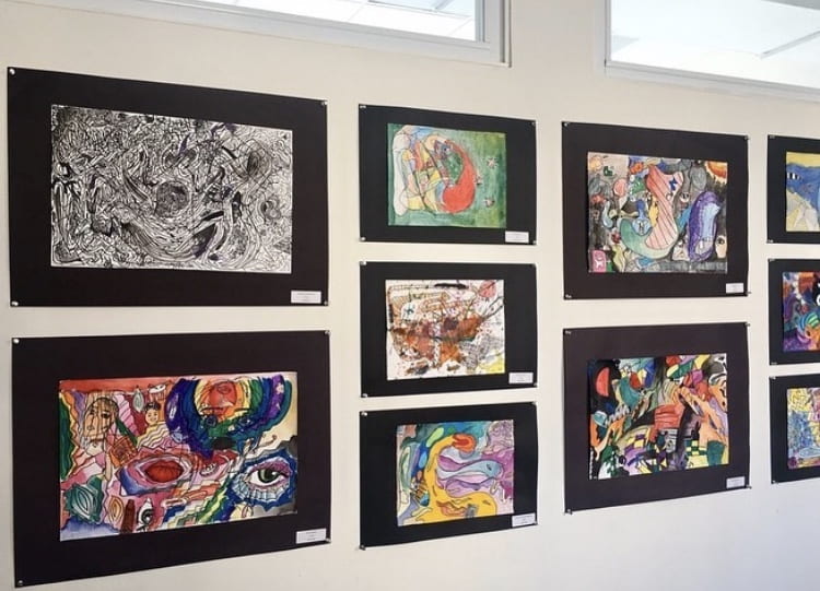 Barney office wall with student artwork on display.