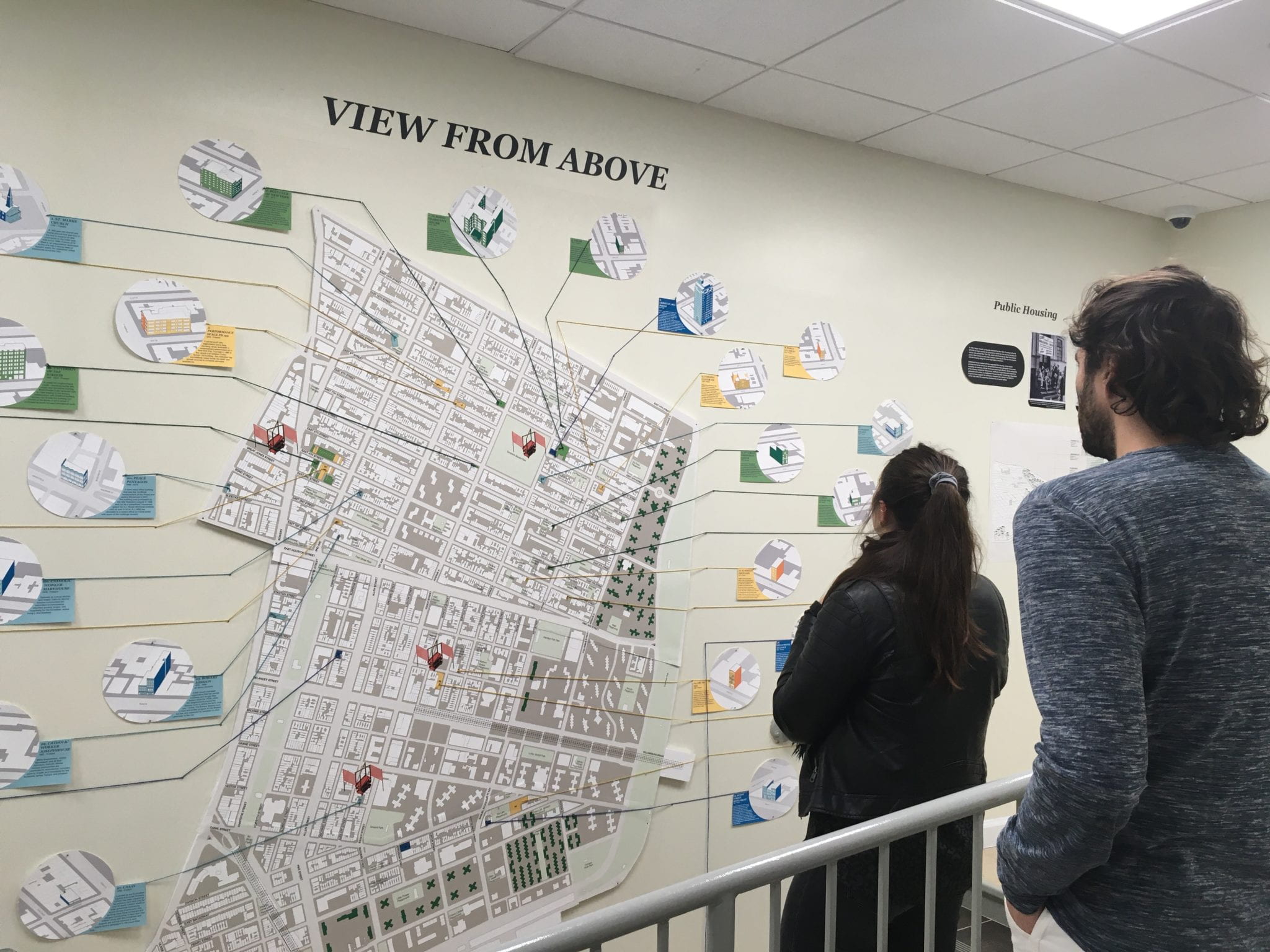 Two students looking at a map of the Lower East Side.