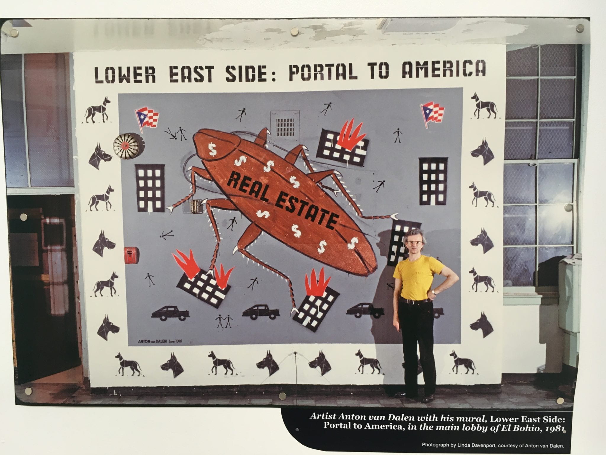 Image of artist with his mural Lower East Side: Portal to America, located in the main lobby of El Bohio, 1981.