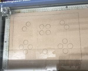 A picture of cardboard in the laser cutter machine.