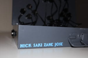 Blue vinyl with Nick, Saki, Zane, and Jose names on the hinge of the metal enclosure