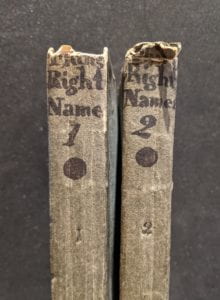 Book spines with handwritten text at top.