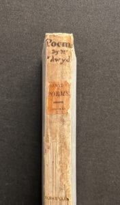 Book spine with handwritten text at top.