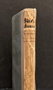 Book spine with handwritten text at top.