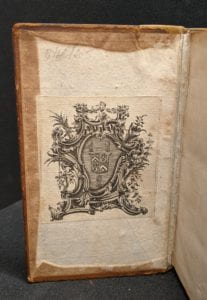 Inside cover of book showing armorial bookplate.