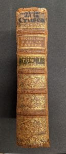 Book spine with handwritten text at top.