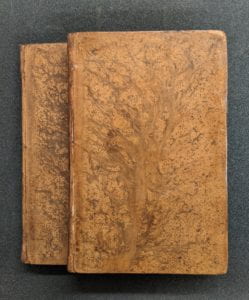 Front covers of two leather bound books.