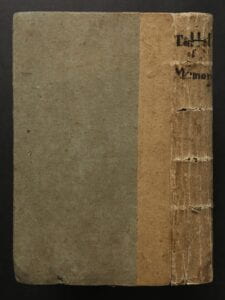 Spine and back cover of book showing binding and handwritten title at head of spine.