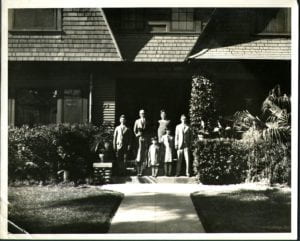 Photograph of Shimanouchi family in front of likely home in Fresno, California. Midori standing in front and center.