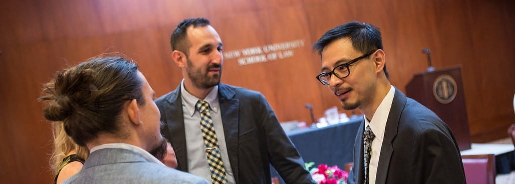 S. Matthew Liao talking with a group of people at a book launch event