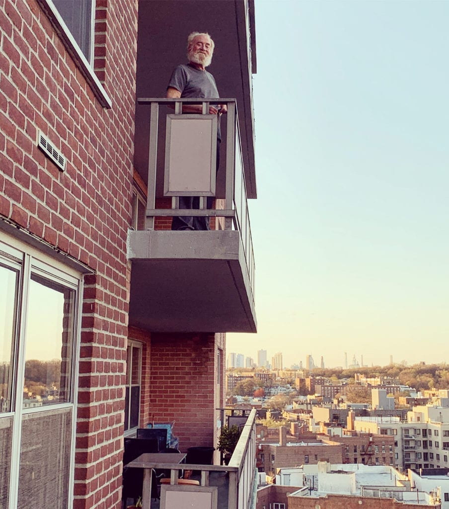 Photo of a view of the Manhattan skyline from my building with my neighbor Duane in the foreground. Taken during the 7pm clap on April 11.