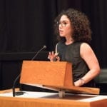 Woman speaking at a lectern