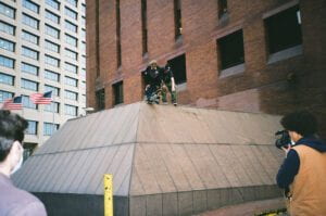 Photograph of skateborder about to go down steep ledge