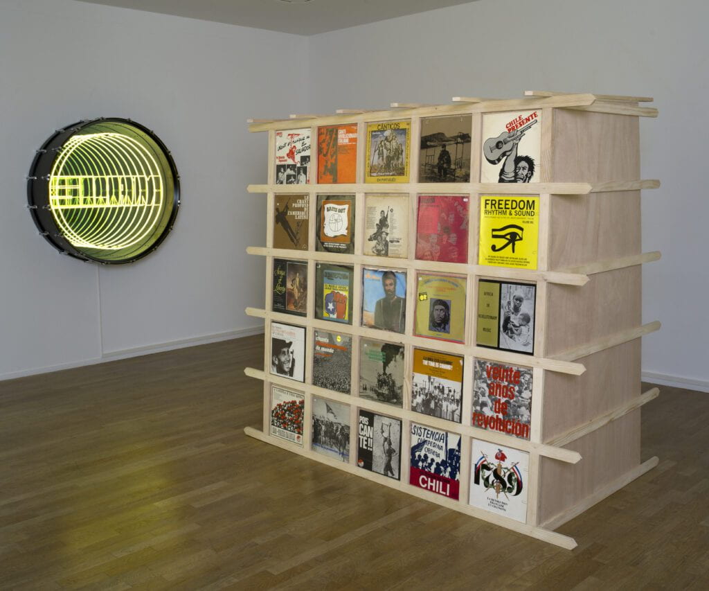 Wood-frame structure with vinyl record cases displayed 