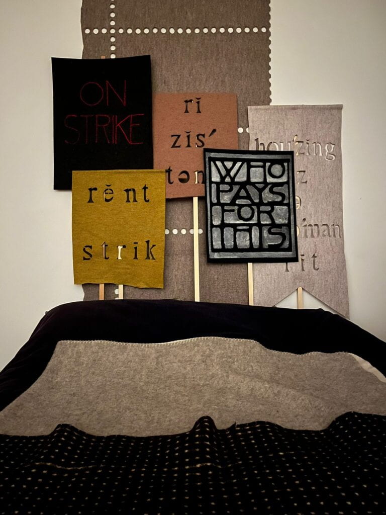 Multiple felt textiles with text and cutouts 