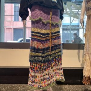 Photograph of a knit, crochet, and woven multicolored skirt on a mannequin 