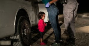 Honduran toddler cries as she and her mother are taken into custody by US border officials.