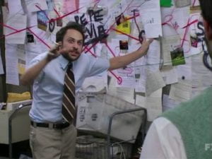 Screen shot of Charlie from "It's Always Sunny in Philadelphia" pointing to a board where he's trying to piece together information and make sense of something with no avail.