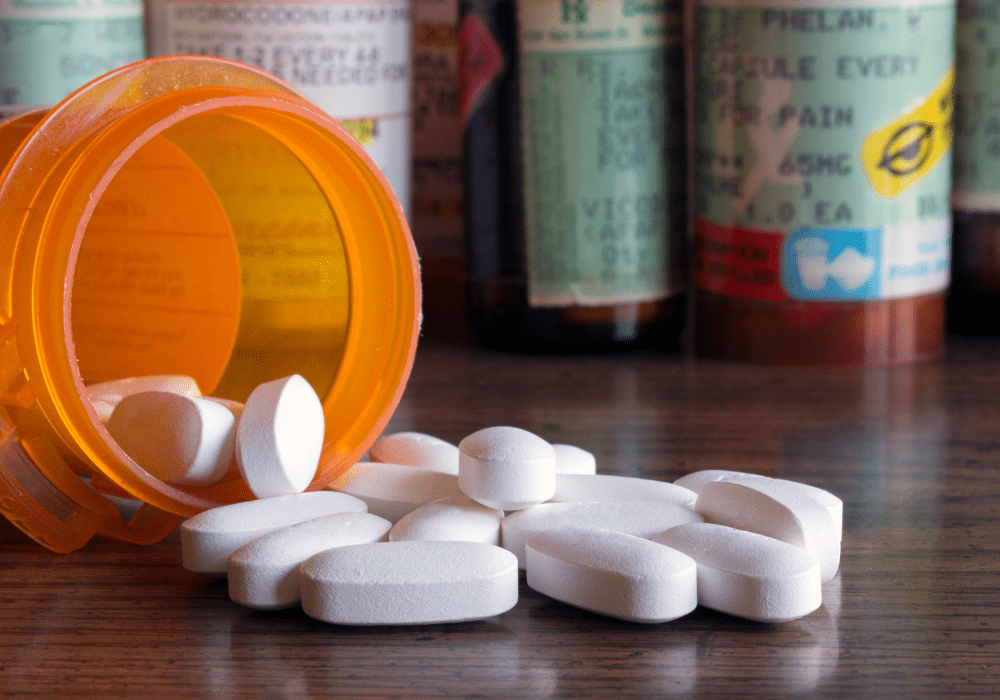 Opioid pills spilling out onto a desk