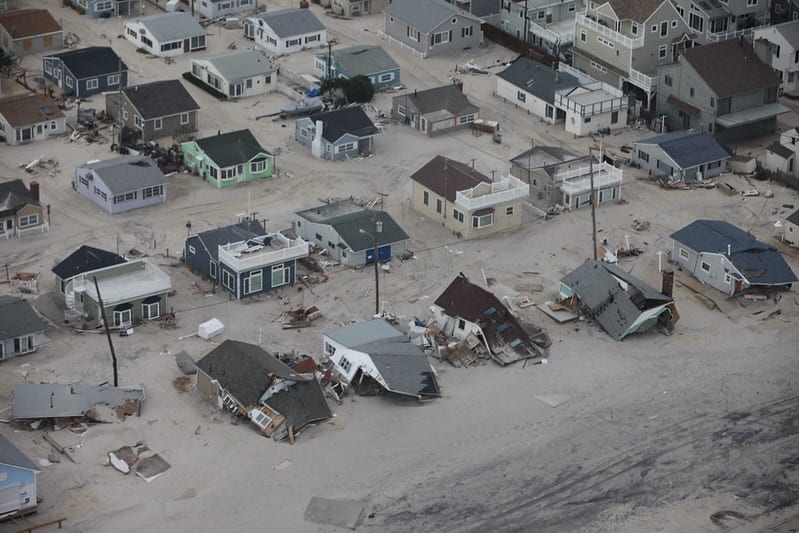 Flooding in a residential neighborhood in New Jersey, showing homes partially submerged in flood waters.