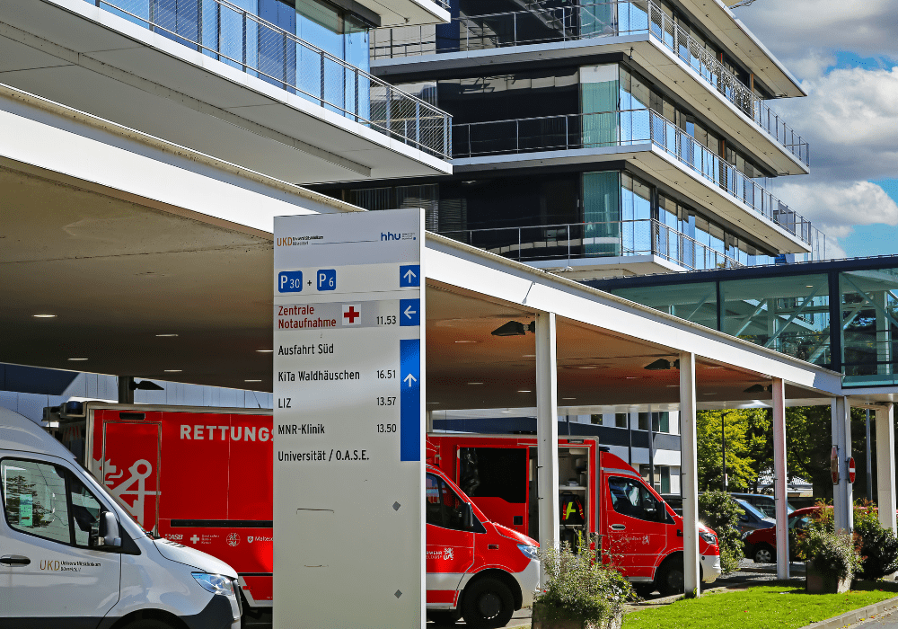 Düsseldorf (UKD), Germany - Juin 9. 2022: Central emergency department of university hospital with red rescue ambulance trucks.