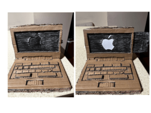 A cardboard laptop with realistic details such as a keyboard and screen. Made entirely of cardboard. It opens and closes thanks to a hinge mechanism. The laptop includes an interactive aspect in which you may pull a paper tab to expose a white Apple logo, which represents the power-on process.