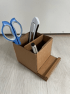 Small cardboard box with scissors and a pen.