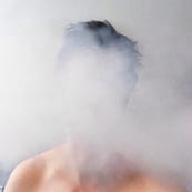 Man with face covered by smoke 